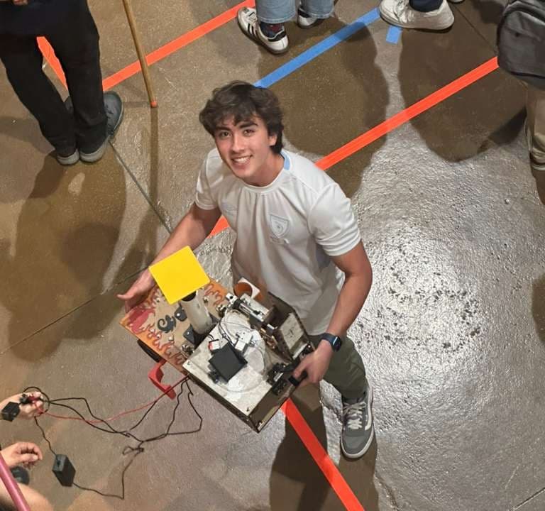 Fabian with a robot he built